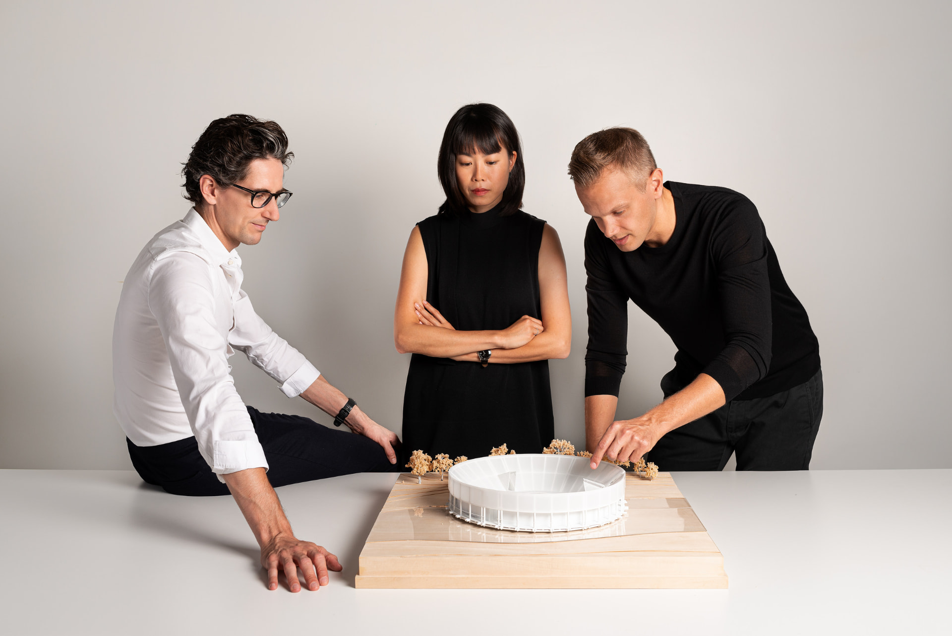 Colleagues reviewing an architectural model in the Superimpose studio